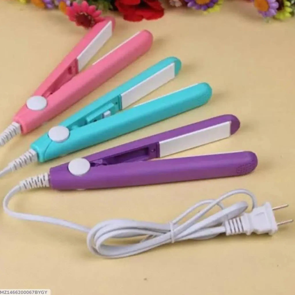 Three Mini NovaHair straighteners in pink, blue, and purple colors laid out on a beige surface with a white power cord